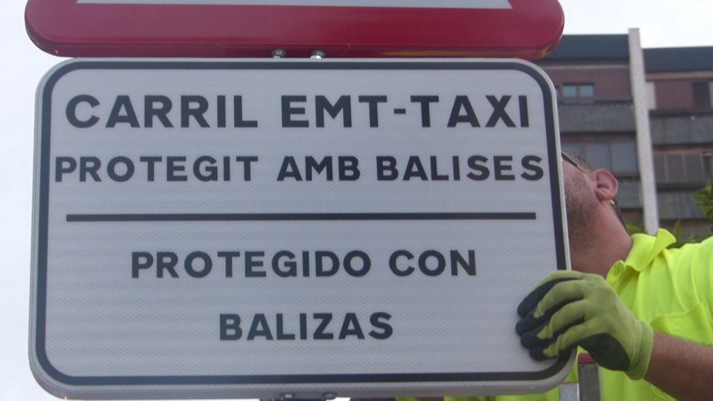 Técnico colocando señales que delimitan los carriles habilitados para los autobuses de EMT y Taxi